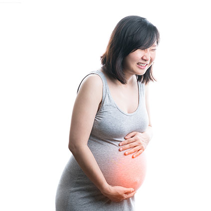 Pregnant woman holding her abdomen with gentle concern symbolizing early pregnancy care and miscarriage awareness